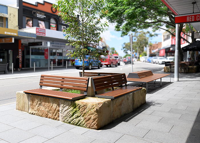 Linea Seat (LIS10, 1500mm) plinth-fixed with aluminium woodgrain Bush Cherry battens, Monument frame.