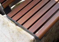 Linea Seat (LIS10, 1500mm) plinth-fixed with aluminium woodgrain Bush Cherry battens, Monument frame.