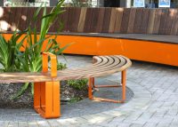 Linea Curved Bench (LIB6-C) in Wood Without Worry aluminium Spotted Gum and Sensation Orange.
