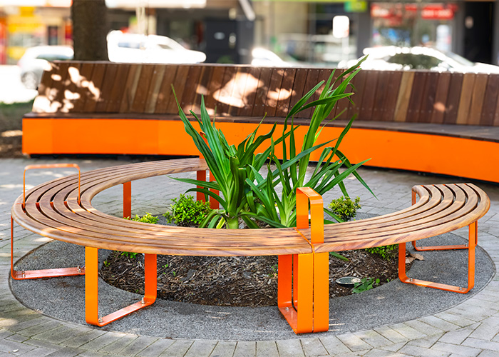 Linea Curved Bench (LIB6-C) in Wood Without Worry aluminium Spotted Gum and Sensation Orange.