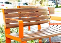 Linea Curved Seat (LIS10-C) in Wood Without Worry aluminium Spotted Gum and Sensation Orange.