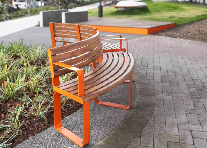 Linea Curved Seat (LIS10-C) in Wood Without Worry aluminium Spotted Gum and Sensation Orange.