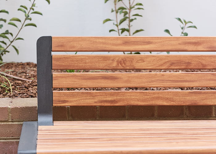 Aria Seat, woodgrain aluminium battens in Spotted Gum, frame in Textura Monument.