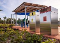 Escola Bin Enclosure (WBE-E120) in stainless steel, Circle insert in Brilliant Yellow, Rectangle in Lobster Red.