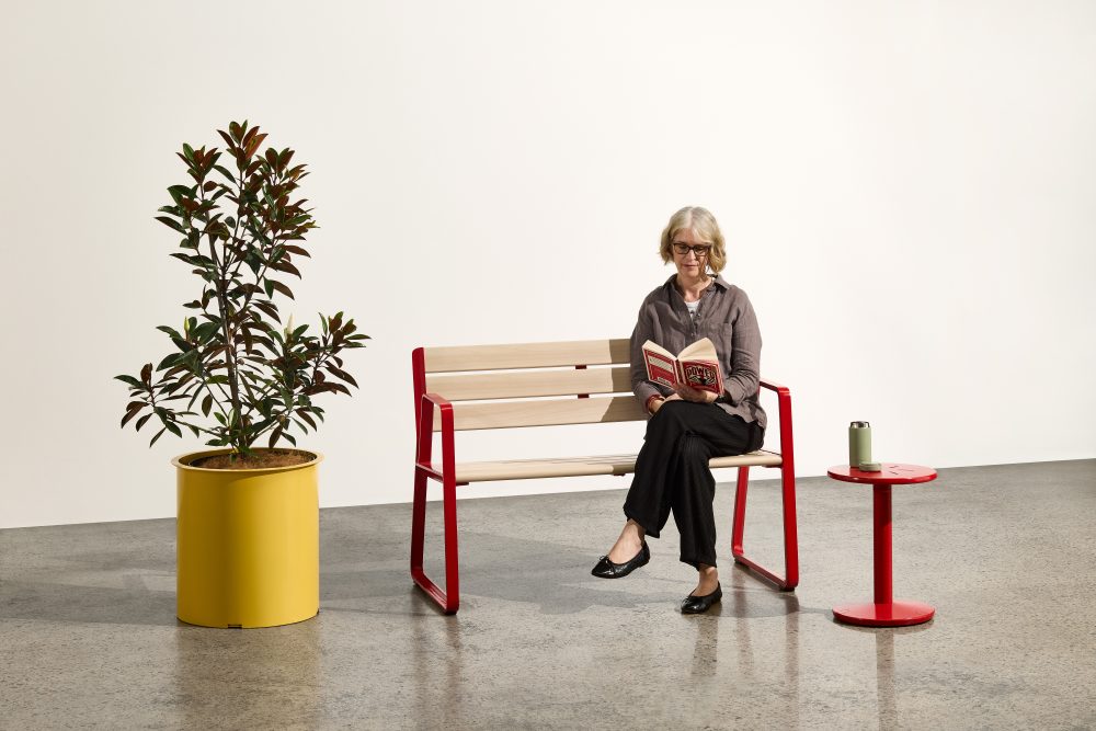 Piatto Love Seat (1200mm) with aluminium Curly Birch battens, Pioneer Red frames. Piatto Stool in Pioneer Red and Frame Planter (Round Tall) in Mustard.
