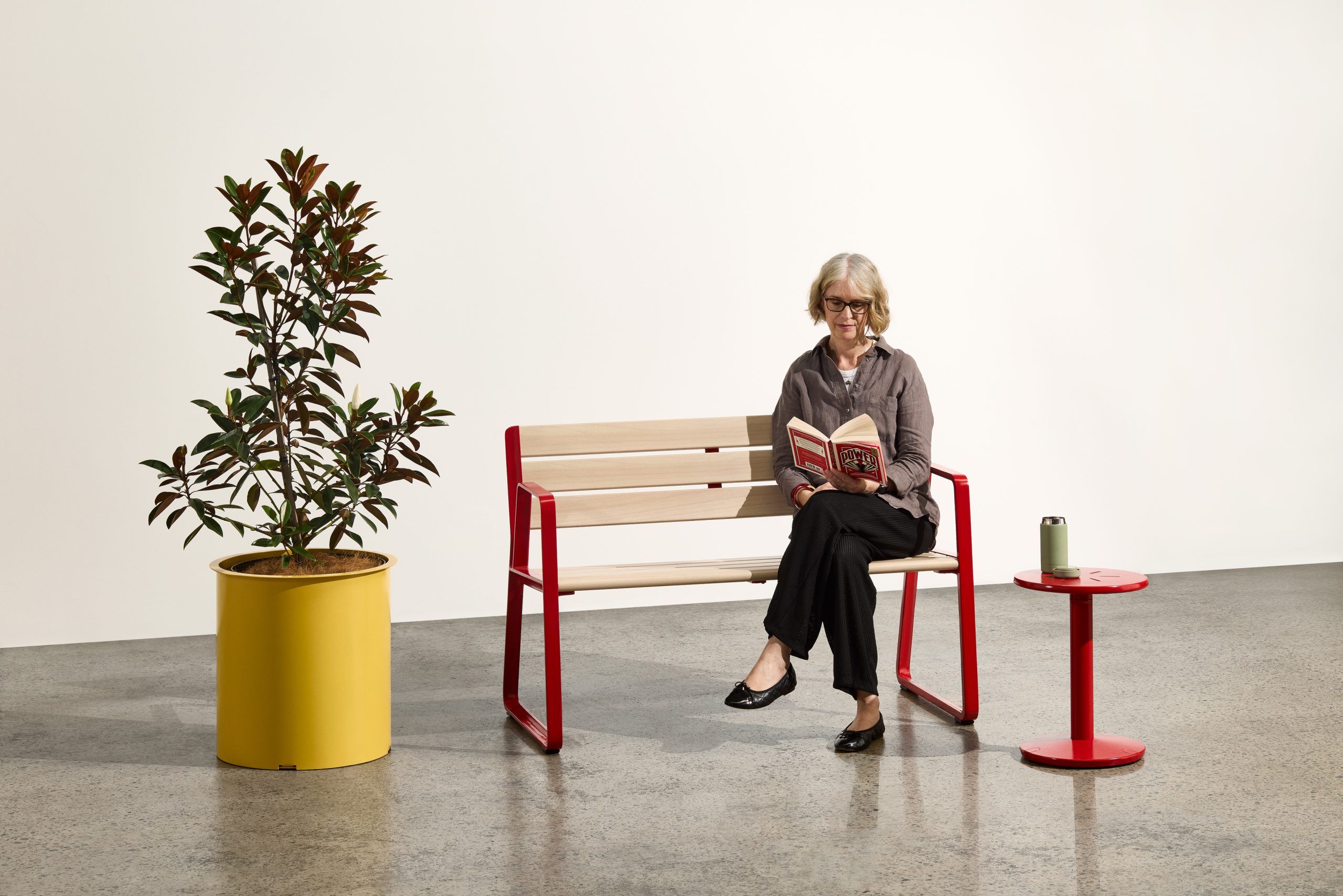 Piatto Love Seat (1200mm) with aluminium Curly Birch battens, Pioneer Red frames. Piatto Stool in Pioneer Red and Frame Planter (Round Tall) in Mustard.
