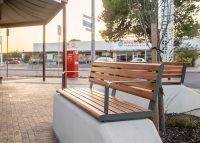 Linea Seat (LIS10, 1500) plinth-fixed with aluminium Spotted Gum battens, Textura Woodland Grey frames.