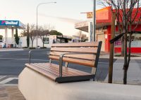 Linea Seat (LIS10, 1500) plinth-fixed with aluminium Spotted Gum battens, Textura Woodland Grey frames.