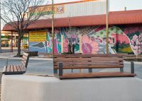Linea Seat (LIS10, 1500) plinth-fixed with aluminium Spotted Gum battens, Textura Woodland Grey frames.