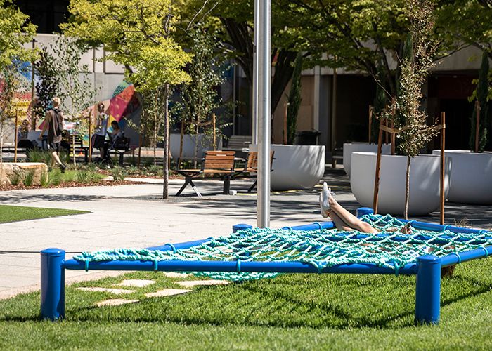 Low rope hammocks for relaxation, above the new lawn.