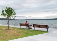 Mall Seat with battens in woodgrain aluminium Bush Cherry, angle arms and frame in Night Sky.