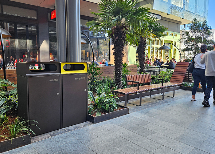 Escola Bin Enclosure (WBE-E120) dual unit in Textura Dark bronze with etched signage, Brilliant Yellow insert.