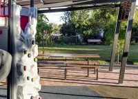 Park DDA Setting, battens in aluminium woodgrain Spotted Gum, frames in Monument.