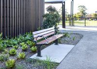 Park DDA Seat, battens in aluminium woodgrain Spotted Gum, frames in Monument.