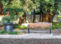 Park DDA Seat, battens in aluminium woodgrain Spotted Gum, frames in Monument.