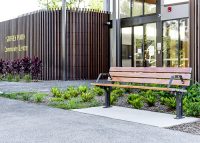 Park DDA Seat, battens in aluminium woodgrain Spotted Gum, frames in Monument.