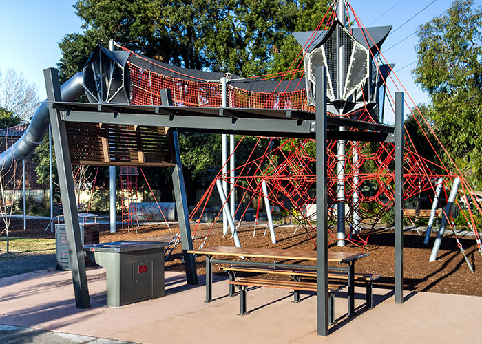 Park DDA Setting with side access, battens in aluminium woodgrain Spotted Gum, frames in Monument.