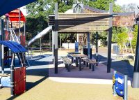 Park DDA Setting, battens in aluminium woodgrain Spotted Gum, frames in Monument.