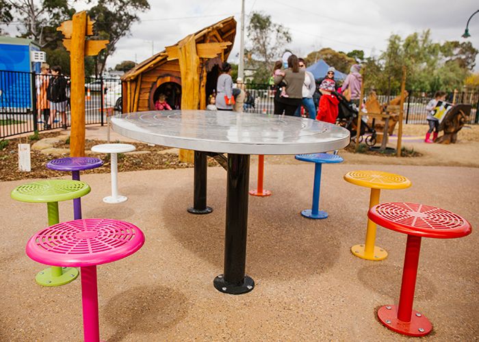 Custom oval tables feature an eaglehawk design, paired with 80 colourful Cafe Stools.