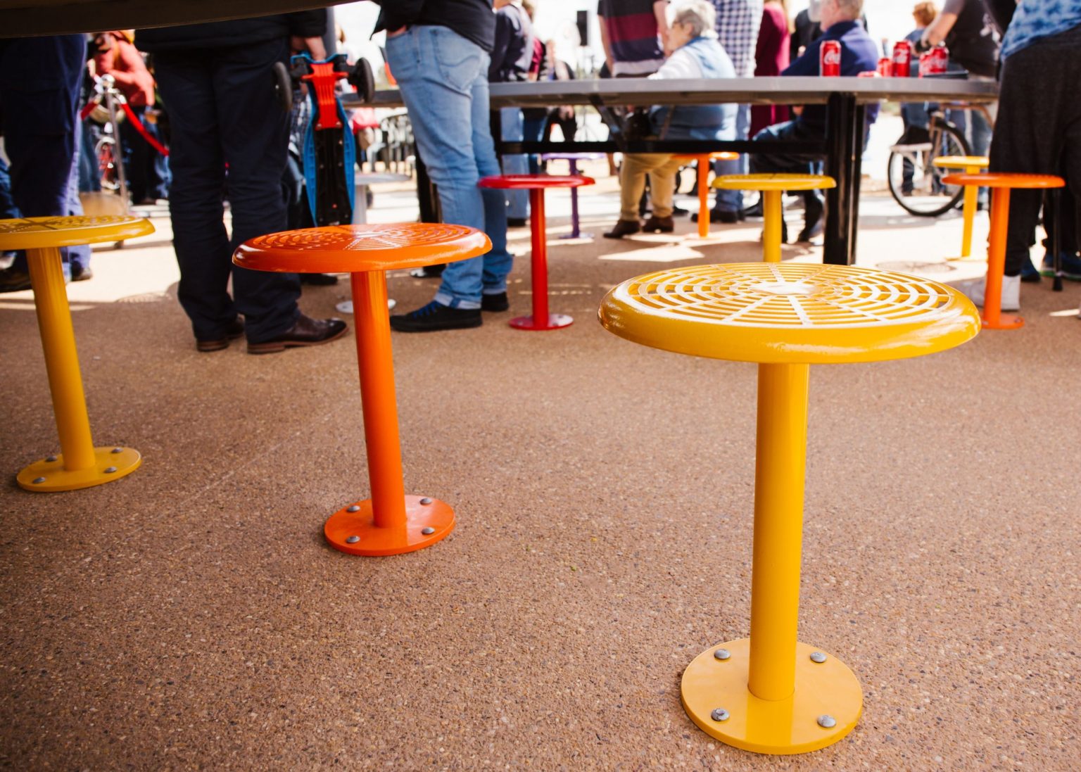 Custom oval tables feature an eaglehawk design, paired with 80 colourful Cafe Stools.