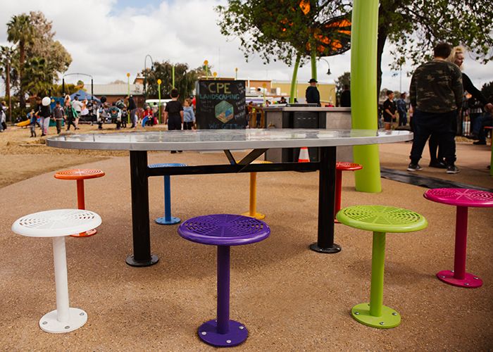 Custom oval tables feature an eaglehawk design, paired with 80 colourful Cafe Stools.