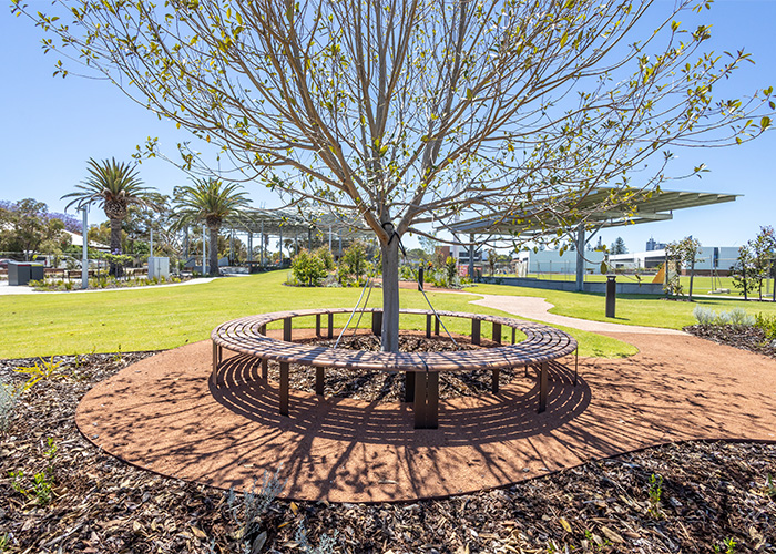 Linea Curved Bench (LIB6-C) with aluminium woodgrain Spotted Gum battens, Textura Dark Bronze frame.