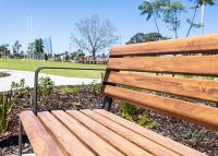 Linea Seat (LIS10, 1800mm) with aluminium woodgrain Spotted Gum battens, Textura Dark Bronze frame.