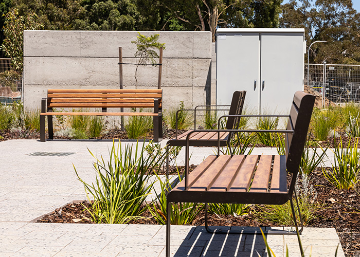 Linea Seat (LIS10, 1800mm) with aluminium woodgrain Spotted Gum battens, Textura Dark Bronze frame.