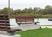 Plinth-mounted Mall DDA Seats with Jarrah battens and frames in tailored colour Metropolis Storm Pearl grey.