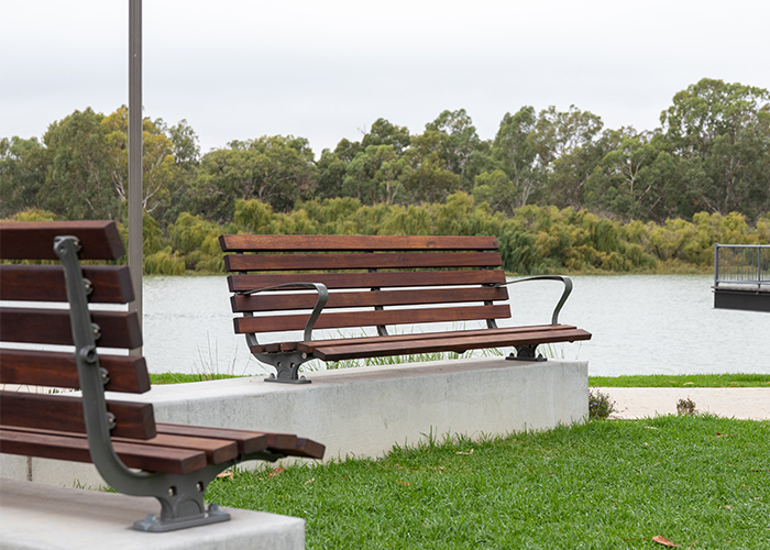 Plinth-mounted Mall DDA Seats with Jarrah battens and frames in tailored colour Metropolis Storm Pearl grey.
