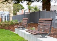 Plinth-mounted Mall DDA Seats with Jarrah battens and frames in tailored colour Metropolis Storm Pearl grey.