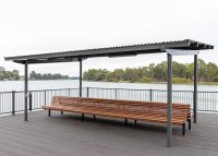Classic Plaza Back-to-Back Seat with aluminium woodgrain battens in Spotted Gum, Sable Bass frame.