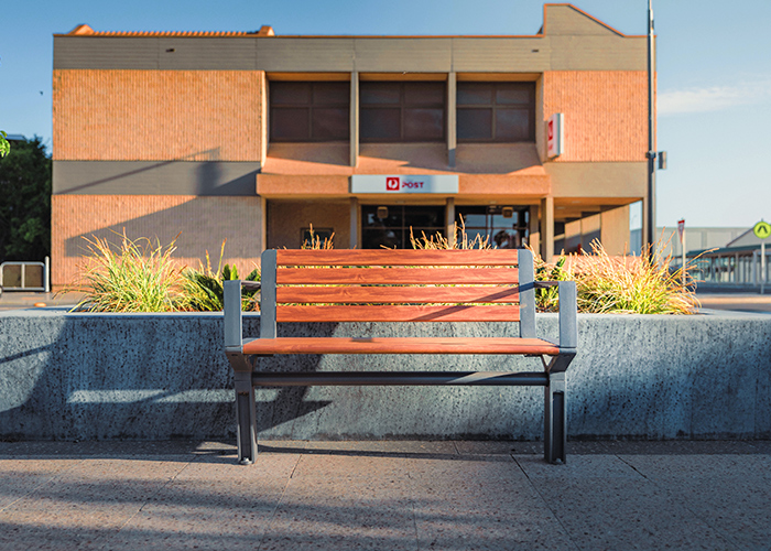 Aria Seat (CMA1, 1200mm) with aluminium woodgrain battens in Spotted Gum, and Sable Brilliance frame.