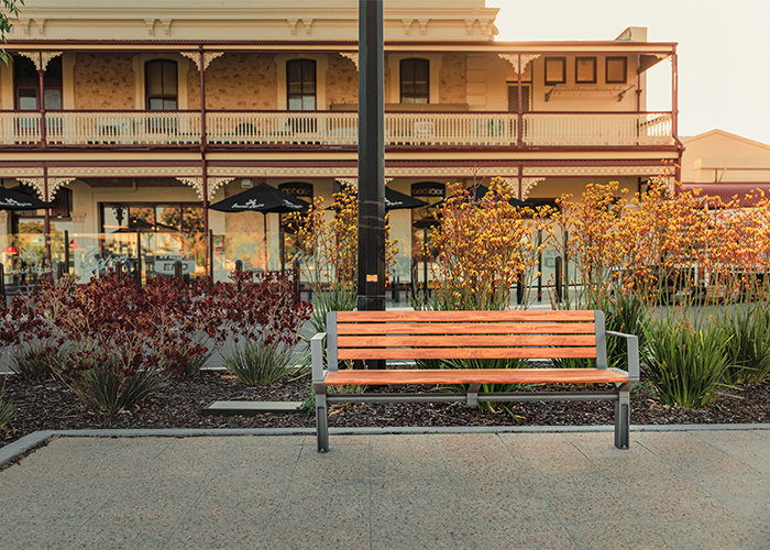 Aria Seat (CMA1, 1800mm) with aluminium woodgrain battens in Spotted Gum, and Sable Brilliance frame.