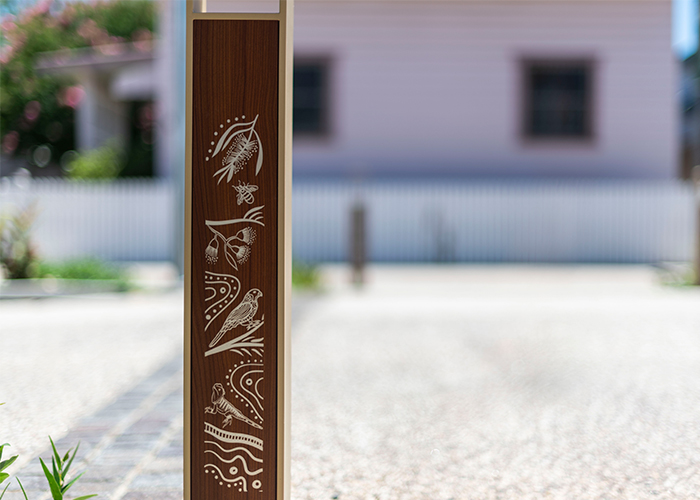 Linea Bollard (B6) with etched artwork, aluminium Bush Cherry insert, Textura Doe Skin frame.