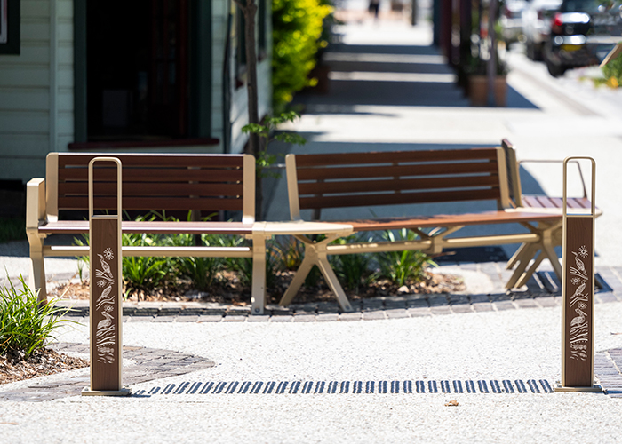 Linea Bollard (B6) with etched artwork, aluminium Bush Cherry insert, Textura Doe Skin frame.