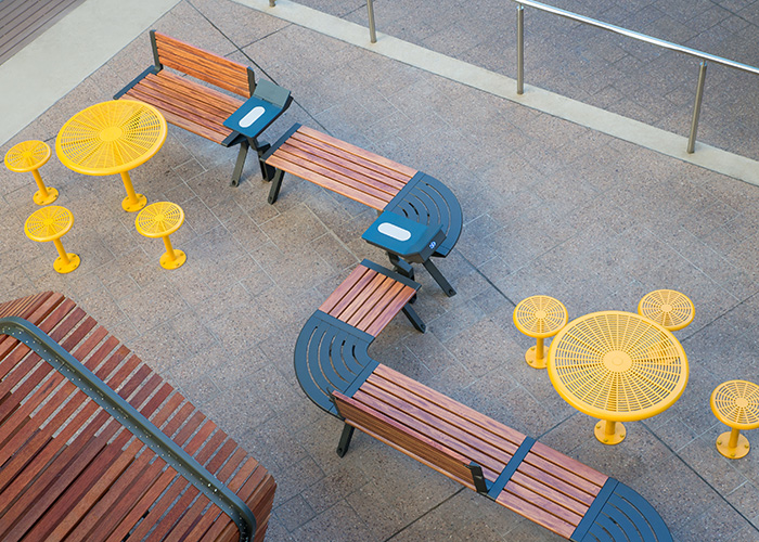 Aria Seating System, woodgrain aluminium battens in Spotted Gum, Textura Monument frames.
