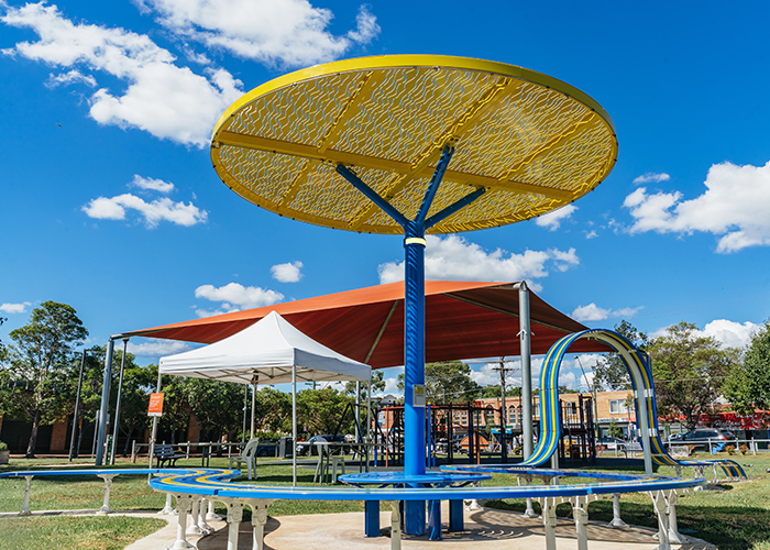 ChillOUT Tree (CT1) with Brilliant Yellow roof, trunk in Bondi Blue. Tailored Mall Curved Slim Bench.