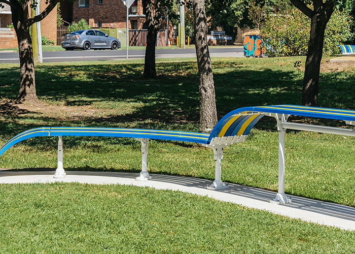 Tailored Mall Curved Slim Bench in Bondi Blue, Jaybird Blue and Brilliant Yellow with Pearl White frame.