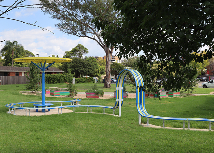 ChillOUT Tree (CT1) with Brilliant Yellow roof, trunk in Bondi Blue. Tailored Mall Curved Slim Bench.