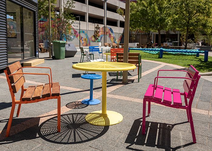 Forum Seats, Cafe Round Table and Stools in Sensation Orange, Telemagenta, Brilliant Yellow, Bondi Blue.