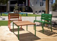 Forum Seats and Low Table on the workspace deck. Frames in Sensation Orange and Shamrock Green.
