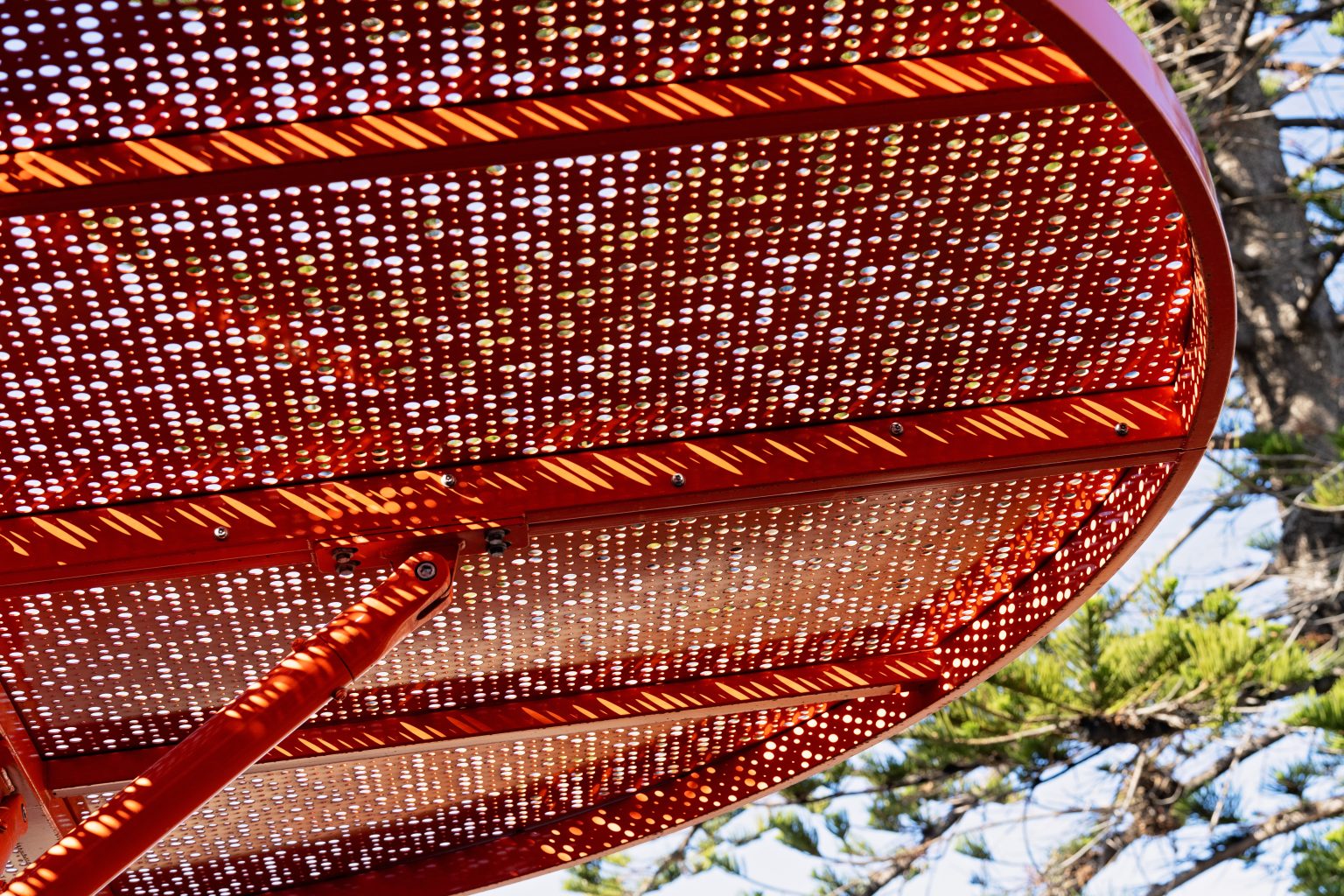 ChillOUT Tree (CT1) flat circular roof in Sensation Orange with Champagne perforated panels.