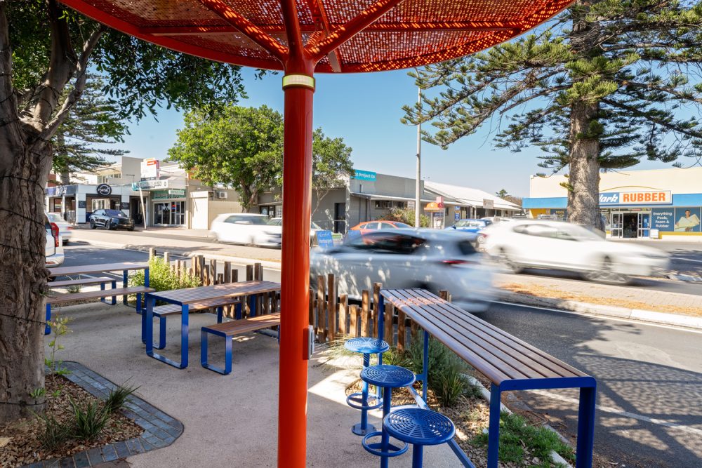 ChillOUT Tree (CT1) powered, in Sensation Orange. Linea Table, Bench and Lookout Bar Table with aluminium Spotted Gum battens, Jaybird Blue frames. Cafe Bar Stool in Jaybird Blue.