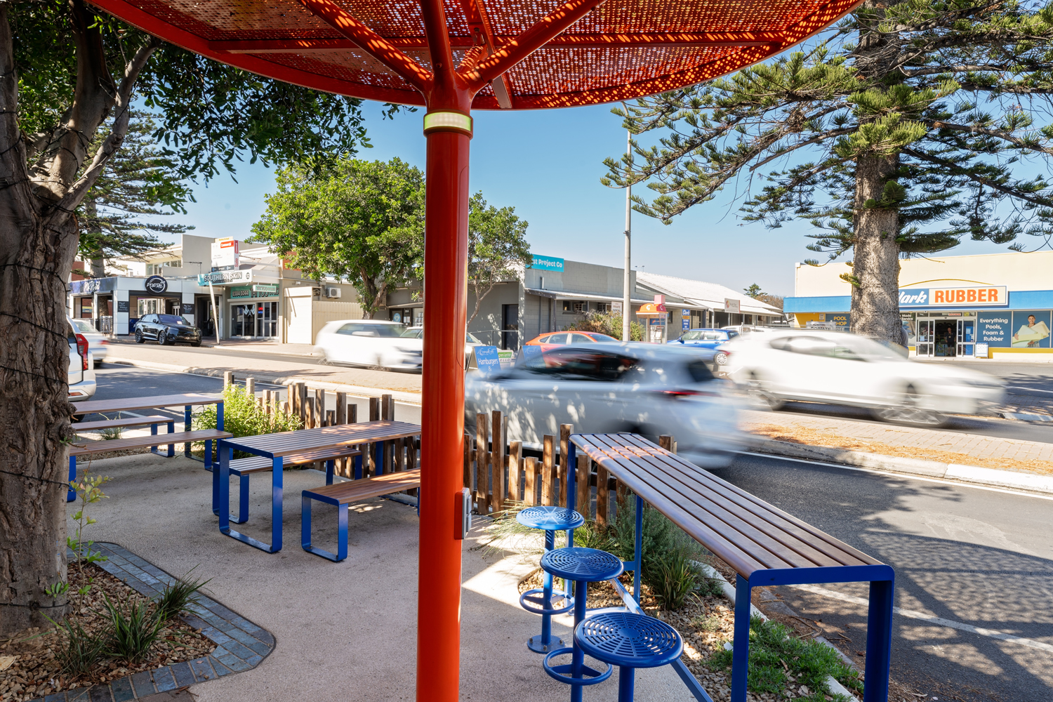 ChillOUT Tree (CT1) powered, in Sensation Orange. Linea Table, Bench and Lookout Bar Table with aluminium Spotted Gum battens, Jaybird Blue frames. Cafe Bar Stool in Jaybird Blue.