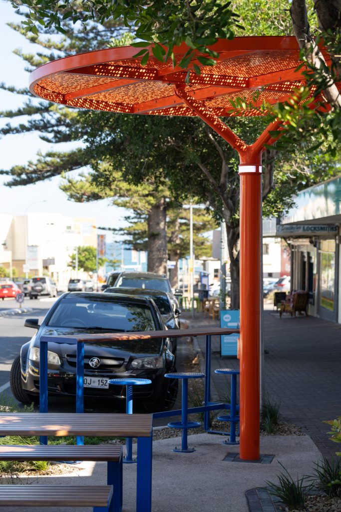 ChillOUT Tree (CT1) powered, with flat circular roof in Sensation Orange and Champagne perforated panels.