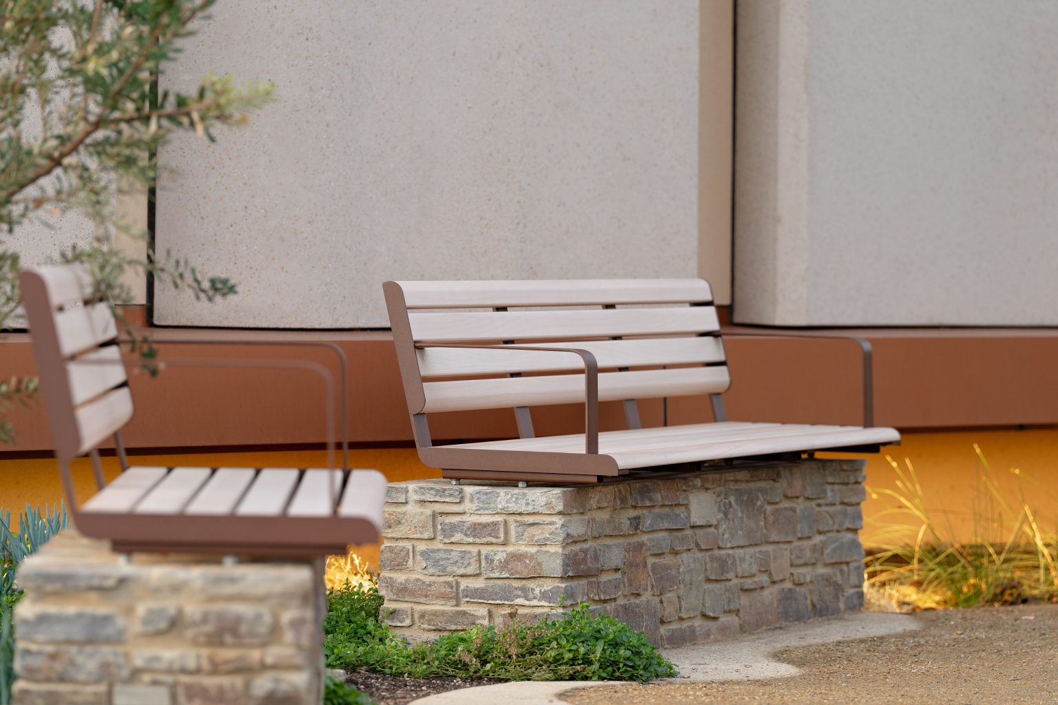 Linea Seat (2100mm, plinth-fixed) with arms, aluminium Curly Birch battens and Textura Core Ten frames.