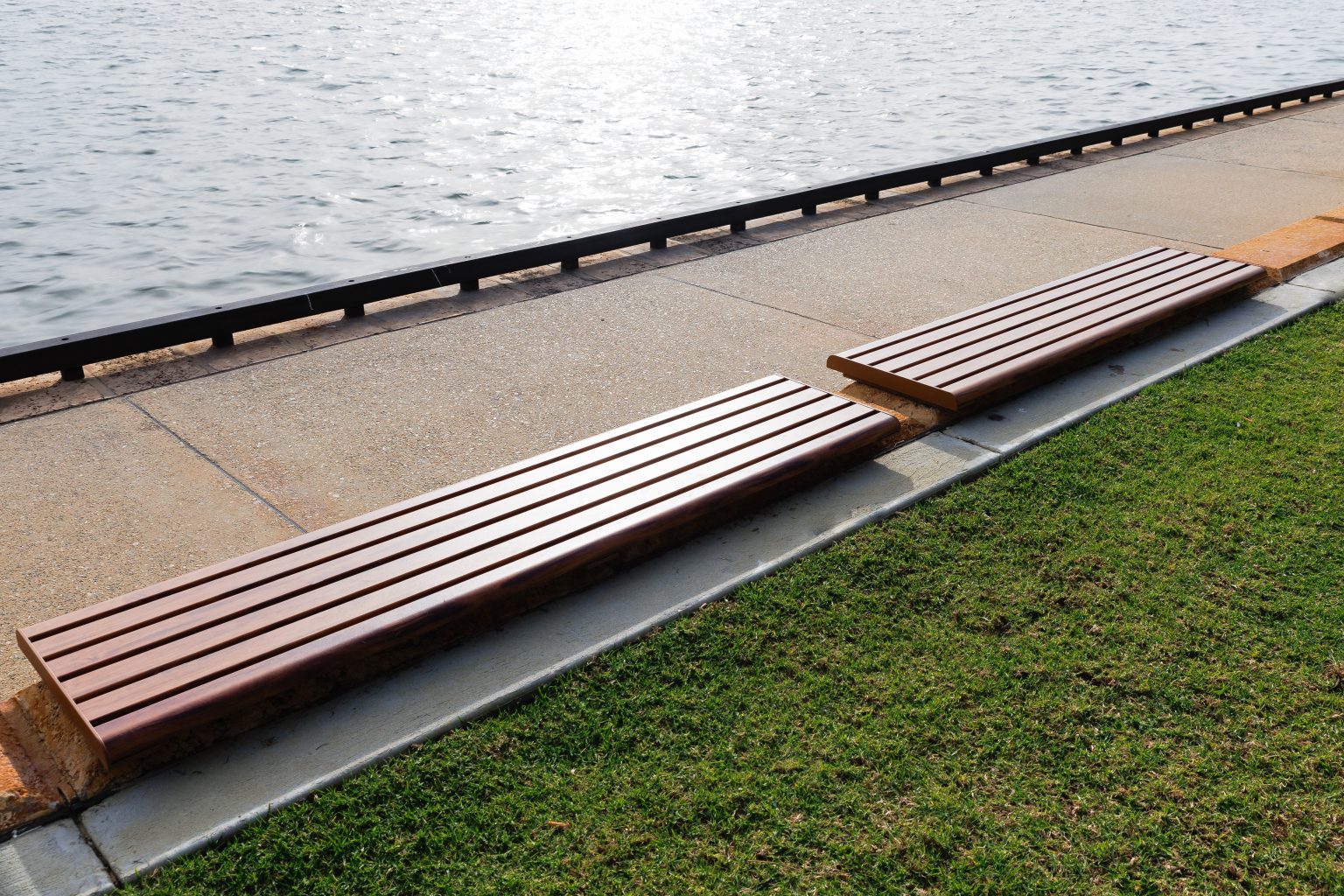 Linea Bench, plinth-fixed 2100mm, with aluminium woodgrain Spotted Gum battens, Textura Russet frames