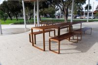 Linea DDA Setting - 2200mm table with end access, 1800mm bench with tall leg - with aluminium woodgrain Spotted Gum battens, Textura Russet frames.