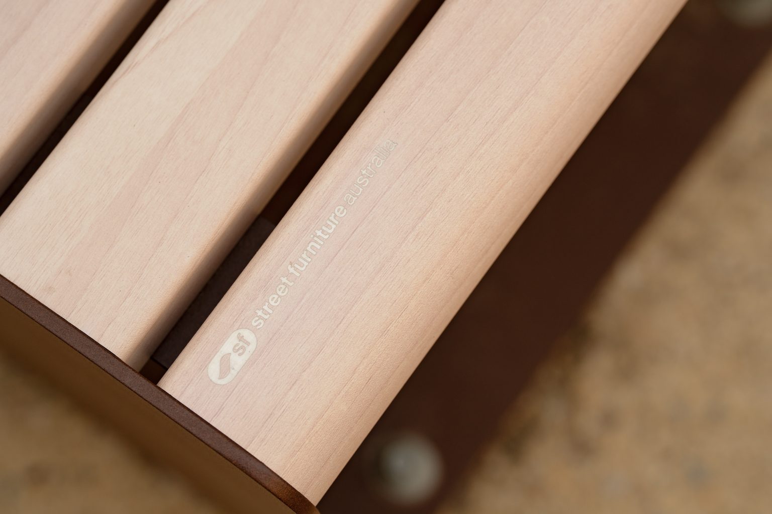 Linea Seat, plinth-fixed, with aluminium Curly Birch battens and Textura Core Ten frames.